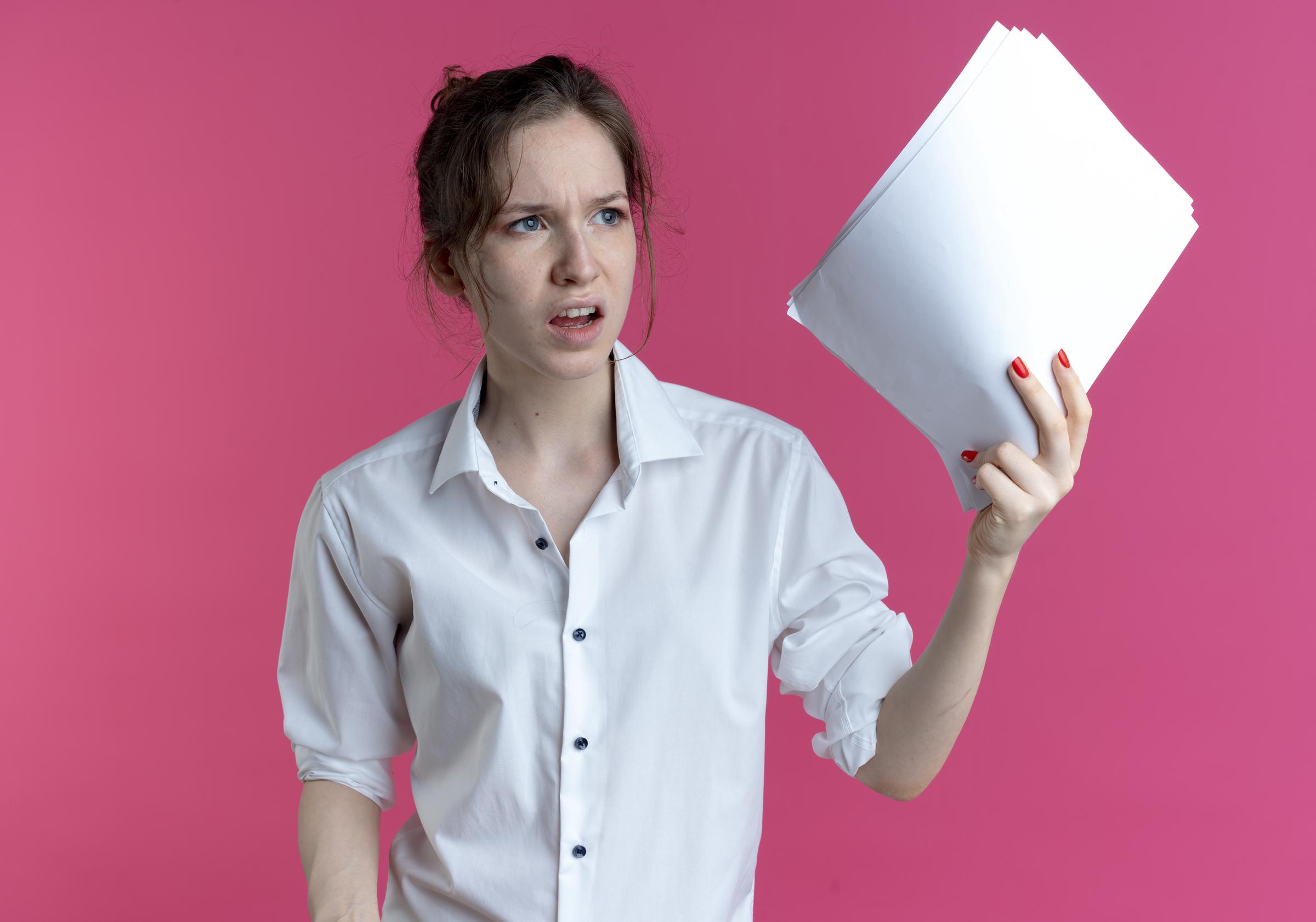 A woman holding up documents | Source: Freepik